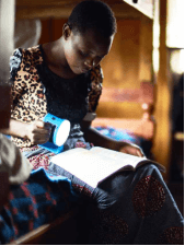 woman reading book with flashlight